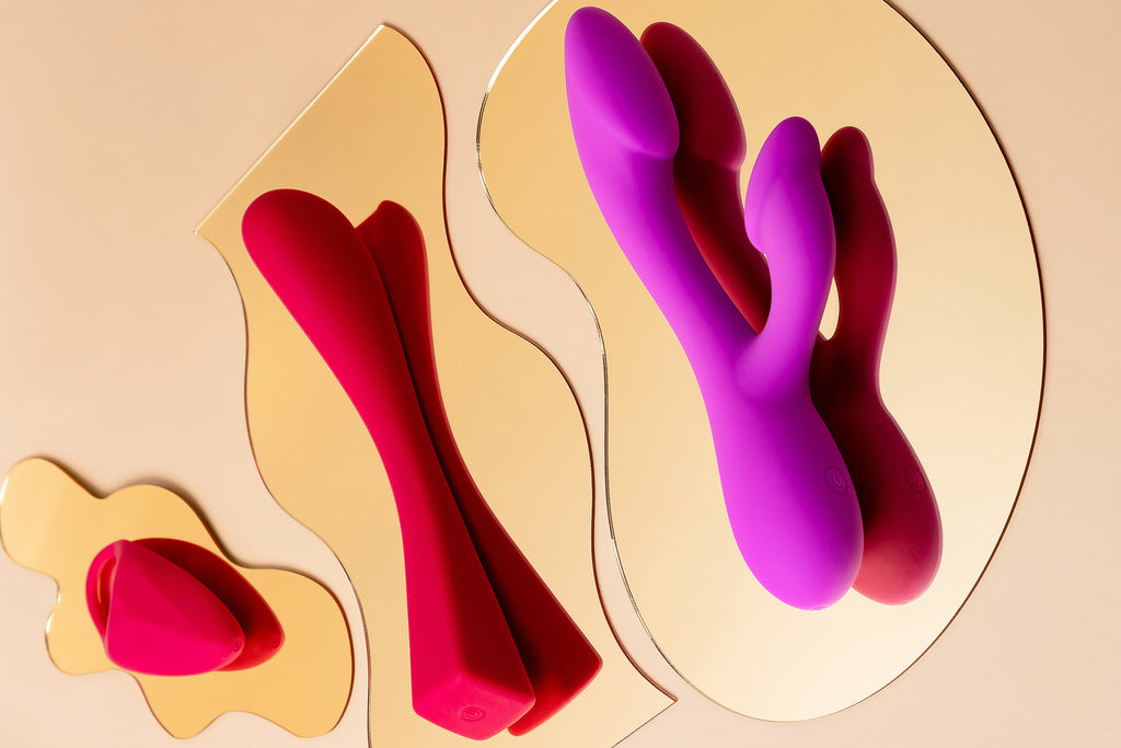 Elixir Play vibrator collection on gold plate background